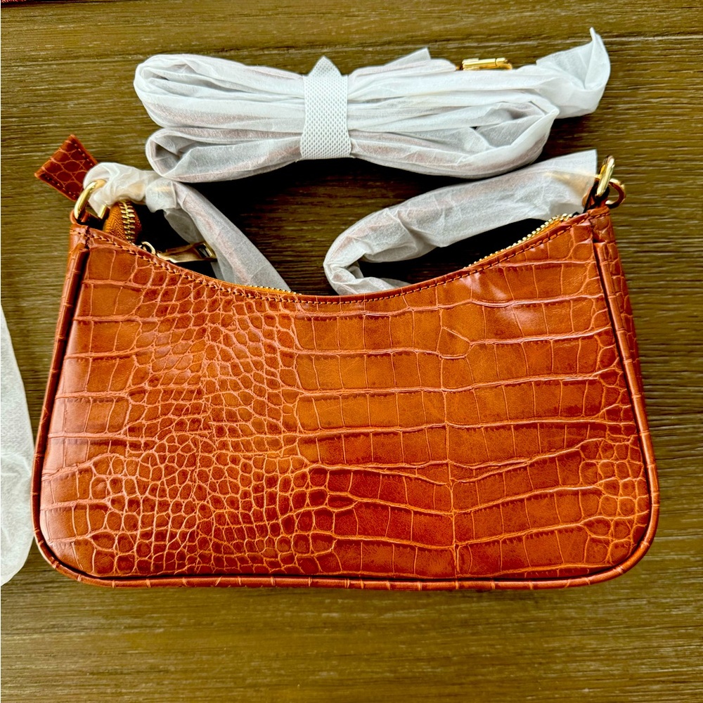 New purse, Still in packaging. Shoulder strap plus crossbody strap included.